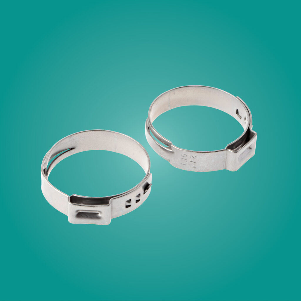 2 stainless steel Oetiker clamps on teal background