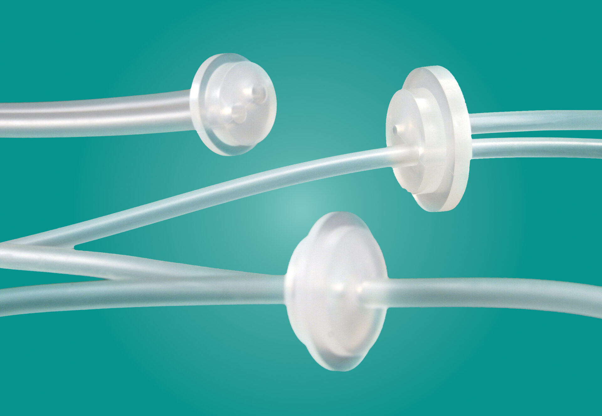 BioClosures molded to tubing on a teal background